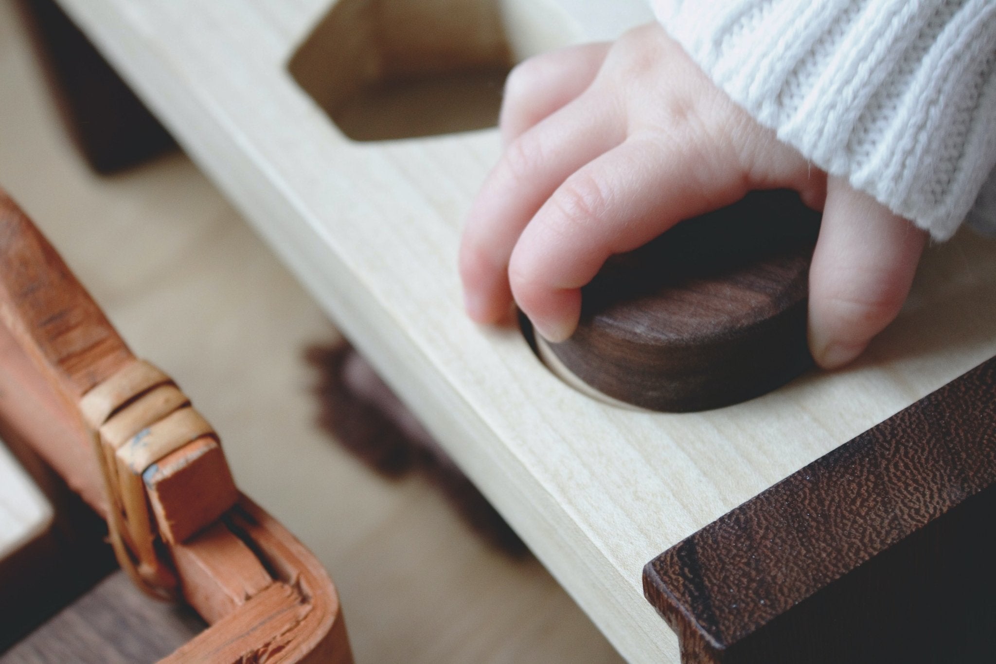 Child engaged in Montessori self-directed learning with wooden educational materials