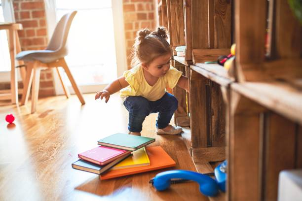 Toddler choosing what to do in a play space with books and toys