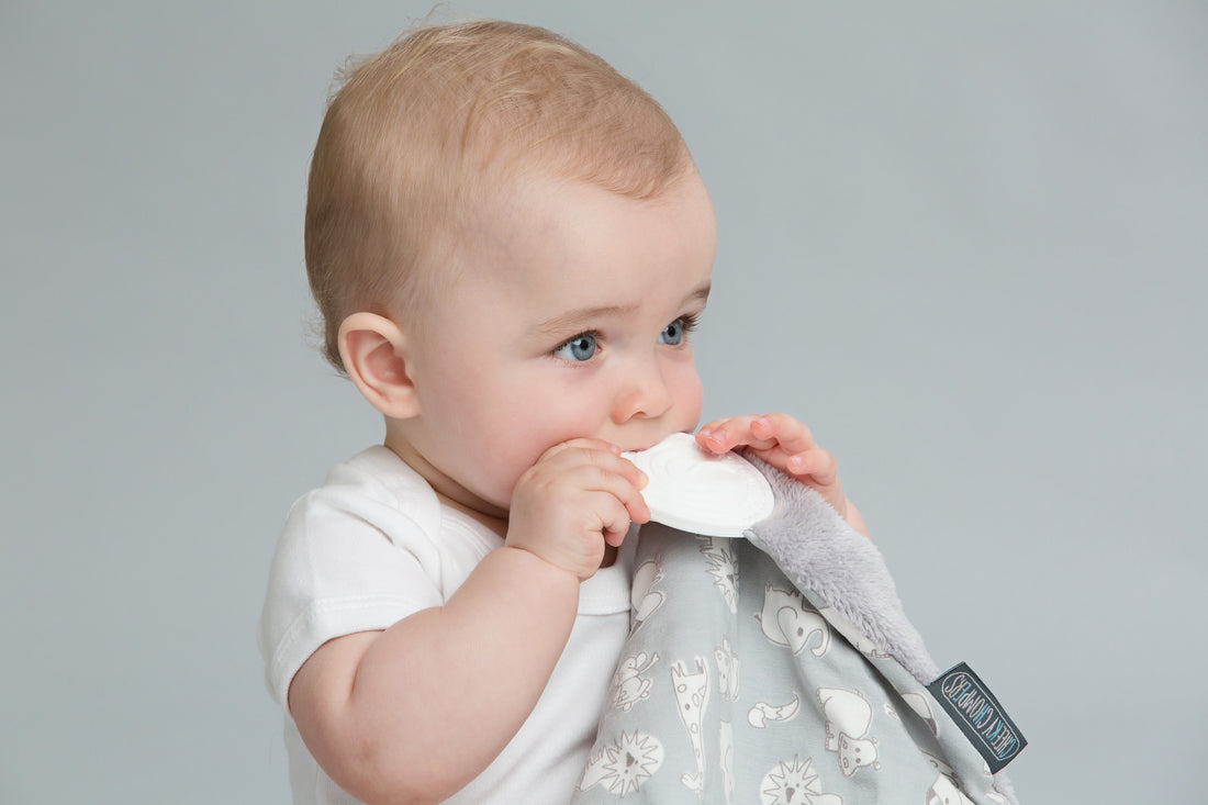 Baby chewing on a teething blanket