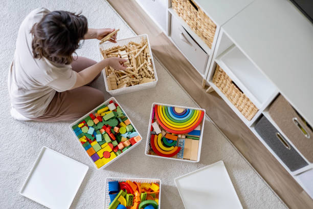 Child organizing wooden Montessori materials in baskets on a low shelf