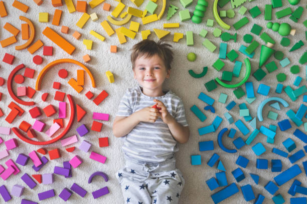 Child surrounded by colorful toys during play