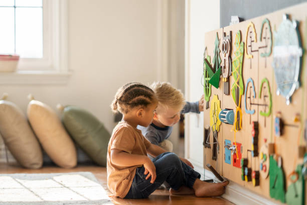 Children playing with a busy board