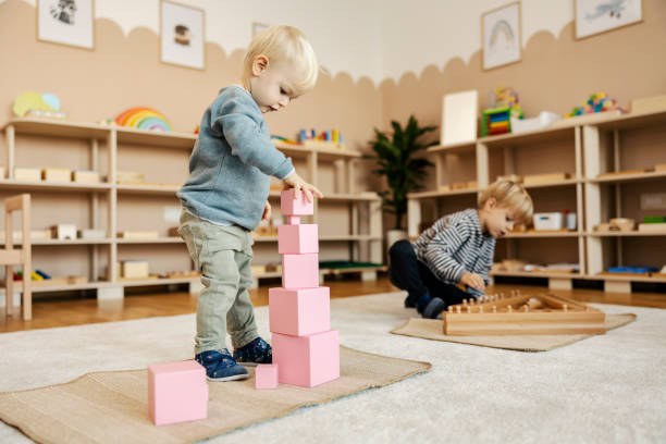 children playing in classroom with wooden blocks