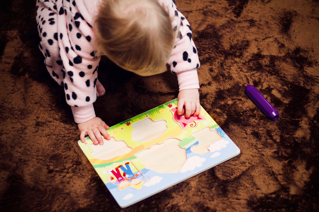 baby playing on the floor with a puzzle