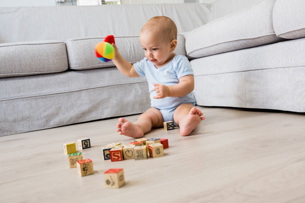 Montessori wooden toys for 1-year-olds from Oliver and Company including rattles and permanence boxes