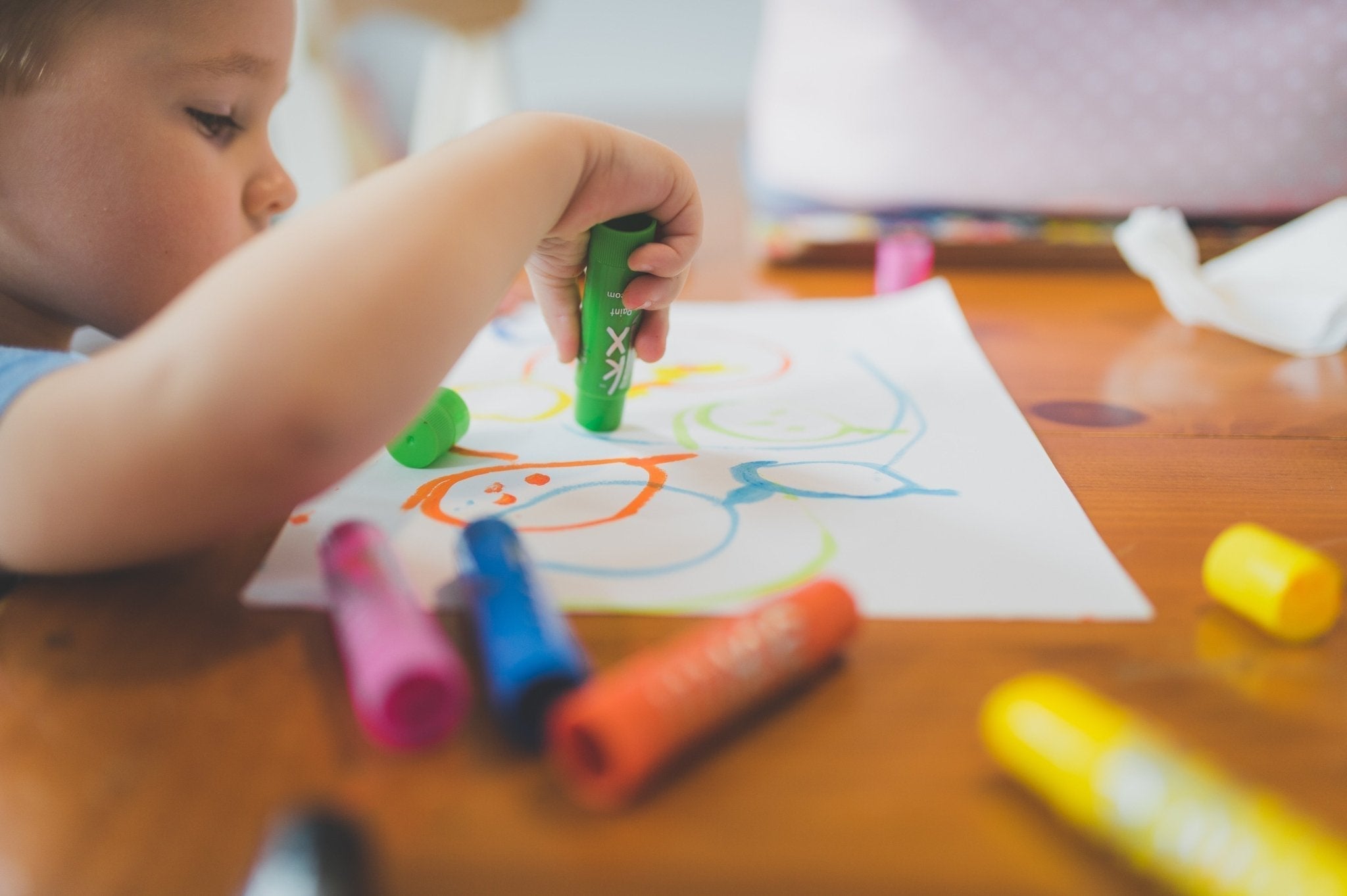 Toddler playing with Montessori wooden toys that build language and communication skills