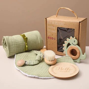 A collection of baby items including a dinosaur-shaped toy, rolled-up white blanket with yellow ribbon, and baby bath mat, embodying eco-friendly early learning.