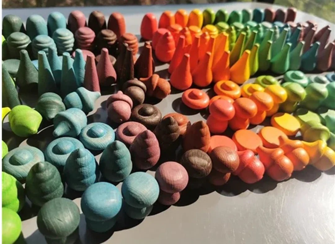 A collection of colorful wooden Montessori toys designed for early learning and independent play, featuring various shapes and sizes.