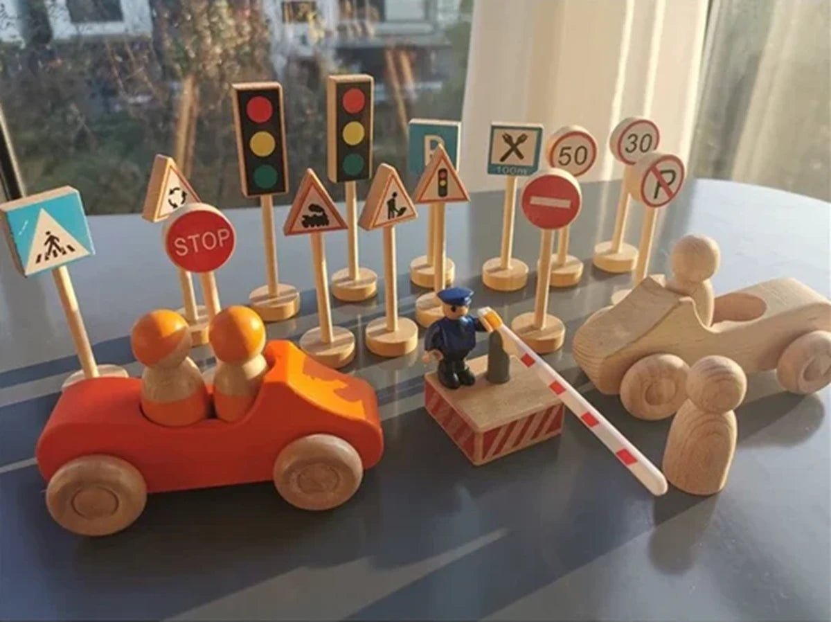 Wooden toy cars and traffic signs with a colorful traffic light, illustrating educational play for toddlers, featured at Oliver & Company Montessori Toys.
