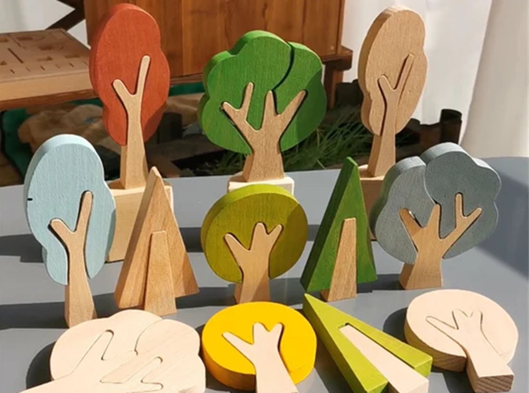 A collection of wooden Montessori toys featuring stylized trees and hand carvings, highlighting eco-friendly design and educational play.
