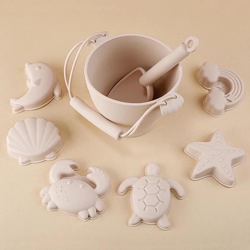 Image of a white ceramic mortar and pestle alongside turtle, starfish, crab, and dolphin-shaped molds, reflecting Montessori educational play tools.