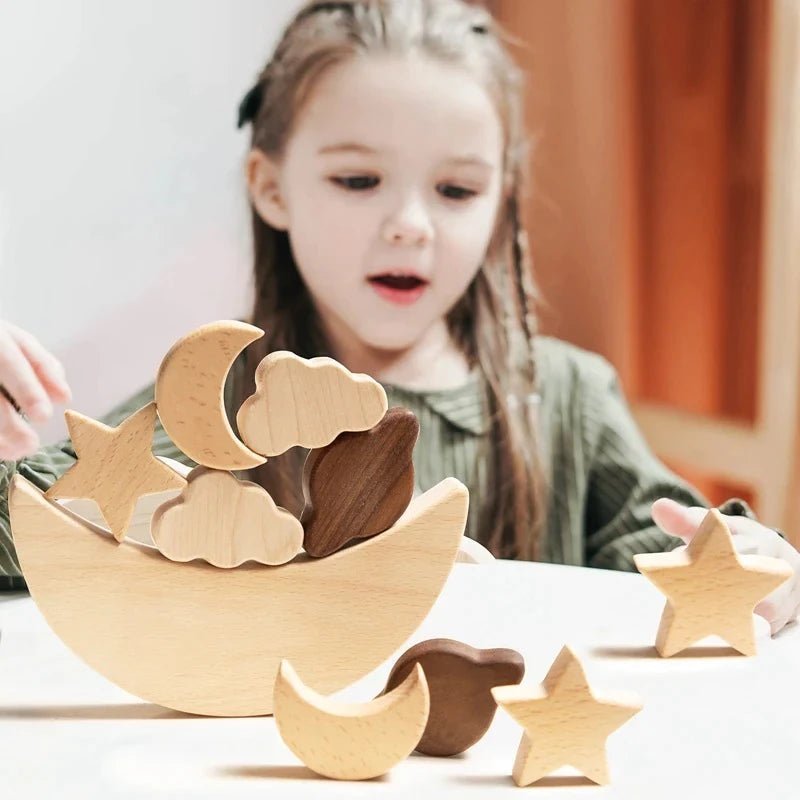 A young girl playing with eco-friendly wooden Montessori toys, featuring a moon and stars, promoting creativity and early learning at Oliver & Company Montessori Toys.