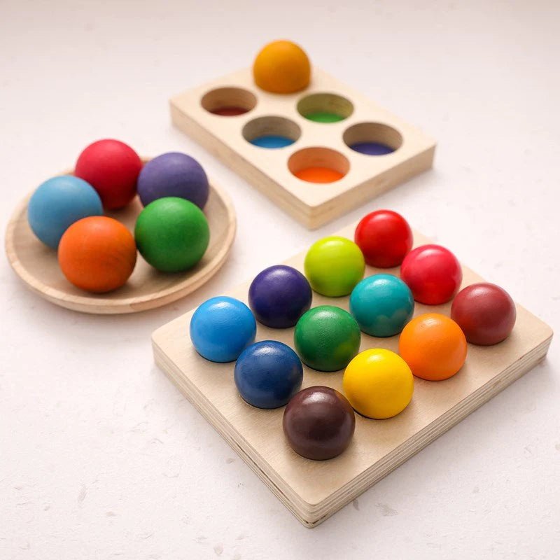 A collection of eco-friendly wooden Montessori toys with colorful balls, including orange, yellow, green, and red, ideal for early learning and play.
