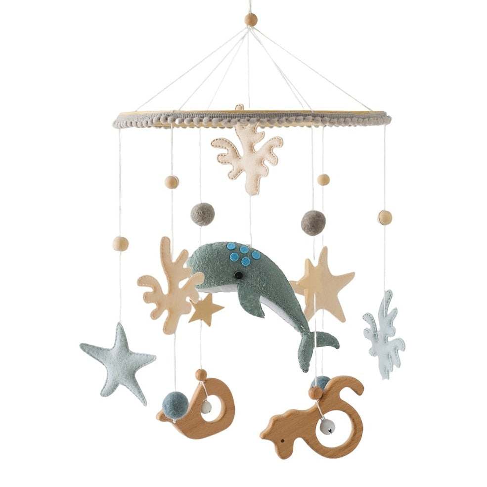 0-12 Months Baby Wooden Whale Crib Mobile featuring wooden toys like a whale, starfish, and bell, designed to soothe and stimulate infants in a nursery setting.