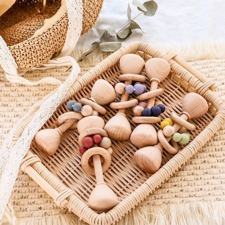 Montessori Beech Wood Baby Rattles in a wicker basket, showcasing natural wooden toys for soothing and entertaining infants, aligned with Oliver & Company Montessori Toys' eco-friendly ethos.