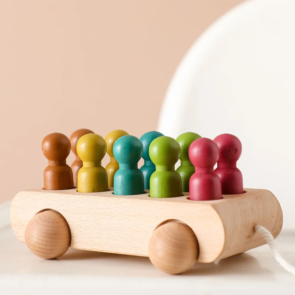 Colorful Wooden Peg Doll Bus with vibrant figures, crafted from beech wood, promoting imaginative play and motor skills development.
