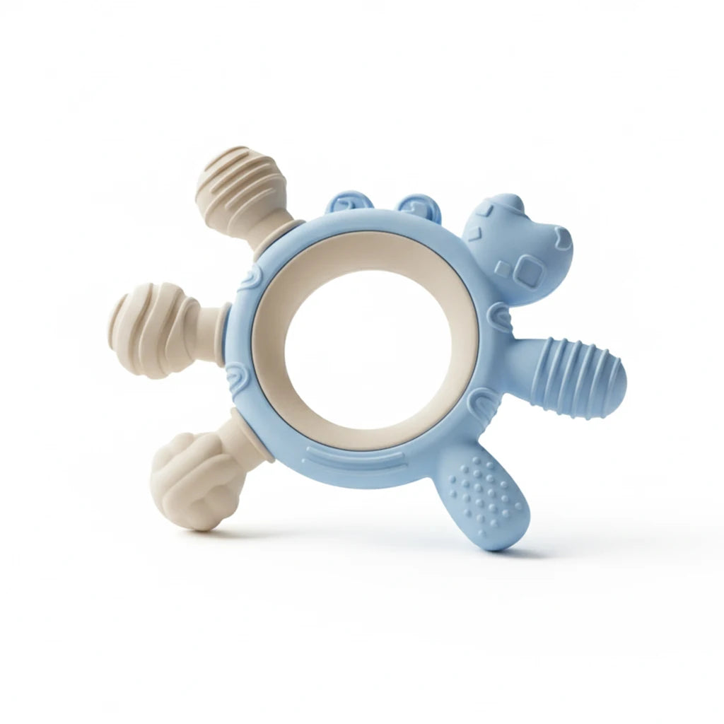 A silicone baby teether with a light blue hippo shape and cream-colored textured grips, shown on a clean white background.