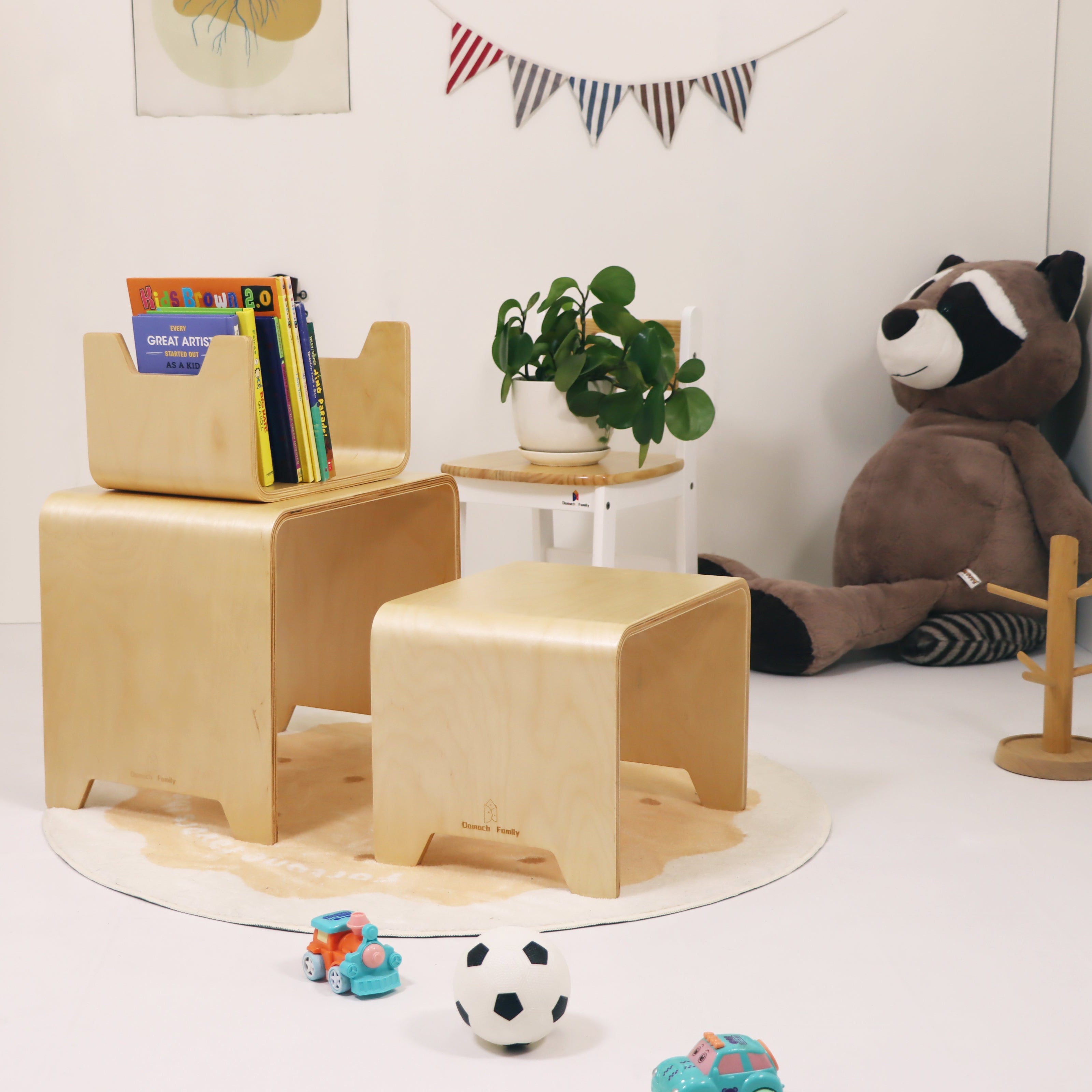 Children's wooden chair and ottoman set with toys and books in a room setting.
