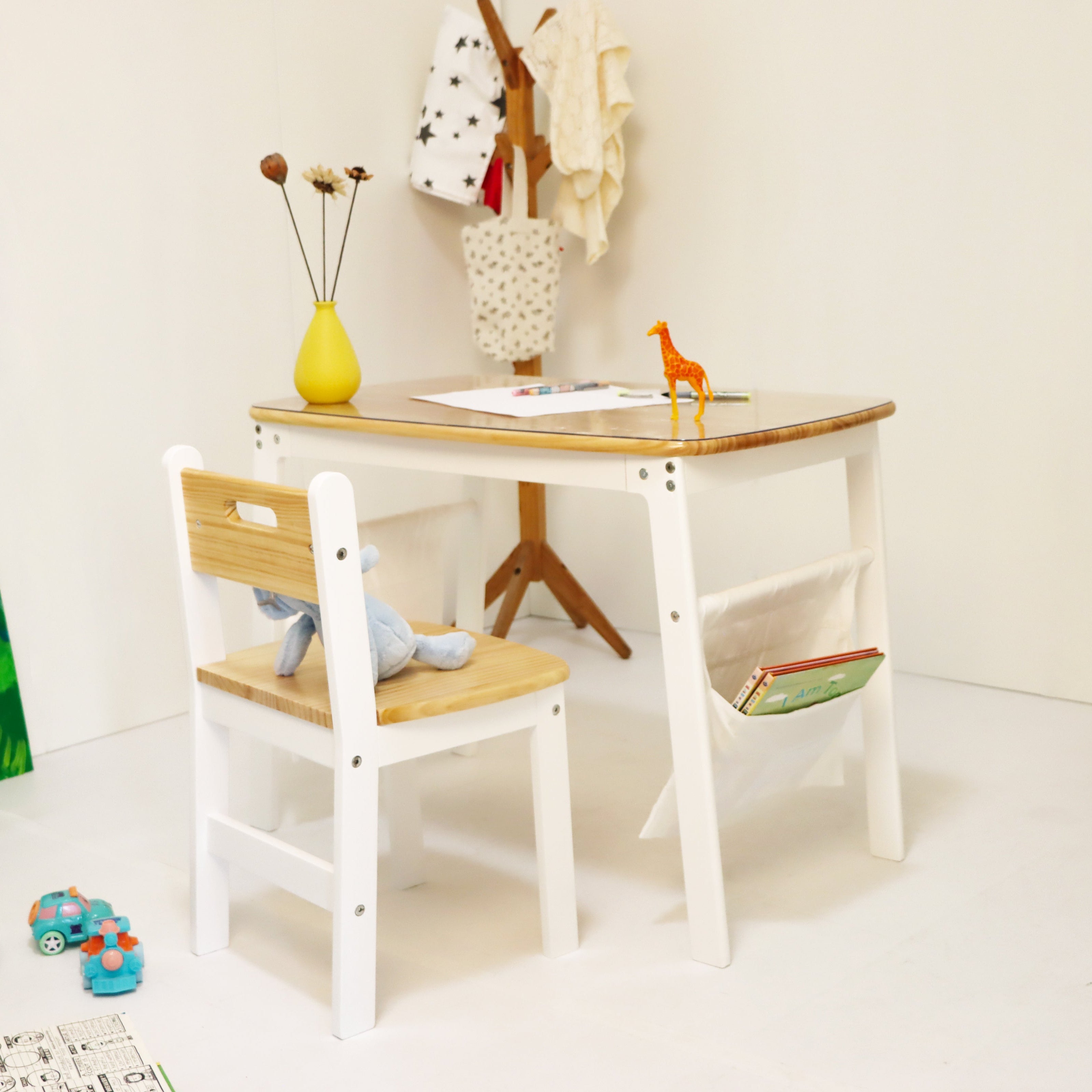 Children's table and chair set with toys and decor in a room.