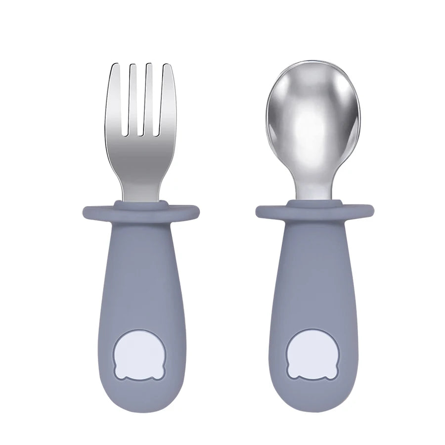 Set of fork and spoon with gray handles on a white background