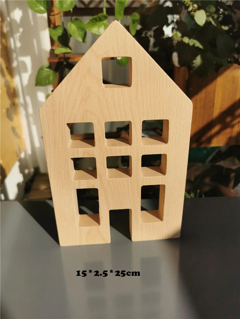Wooden house-shaped object on a reflective surface with a blurred background