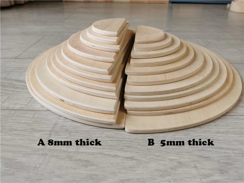 Wooden semi-circles of different thicknesses on a wooden floor