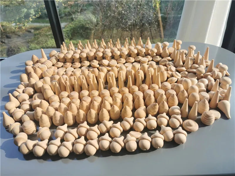 Collection of wooden figurines on a flat surface with a window in the background