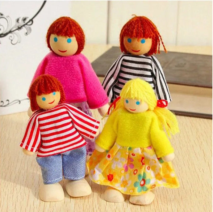 Four colorful dolls with different outfits on a light wooden surface.