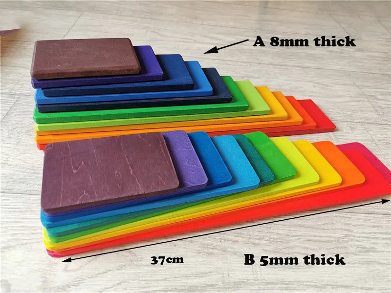 Stack of colorful wooden slats with thickness labels on a wooden floor.