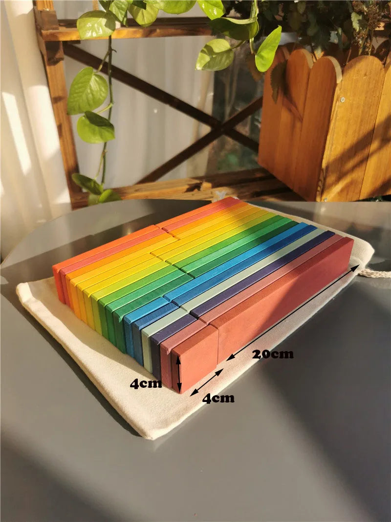 Colorful wooden blocks on a tray with dimensions labeled, placed on a reflective surface.