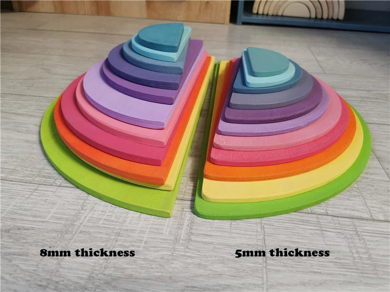Colorful stack of wooden toys with labeled thickness on a wooden floor.