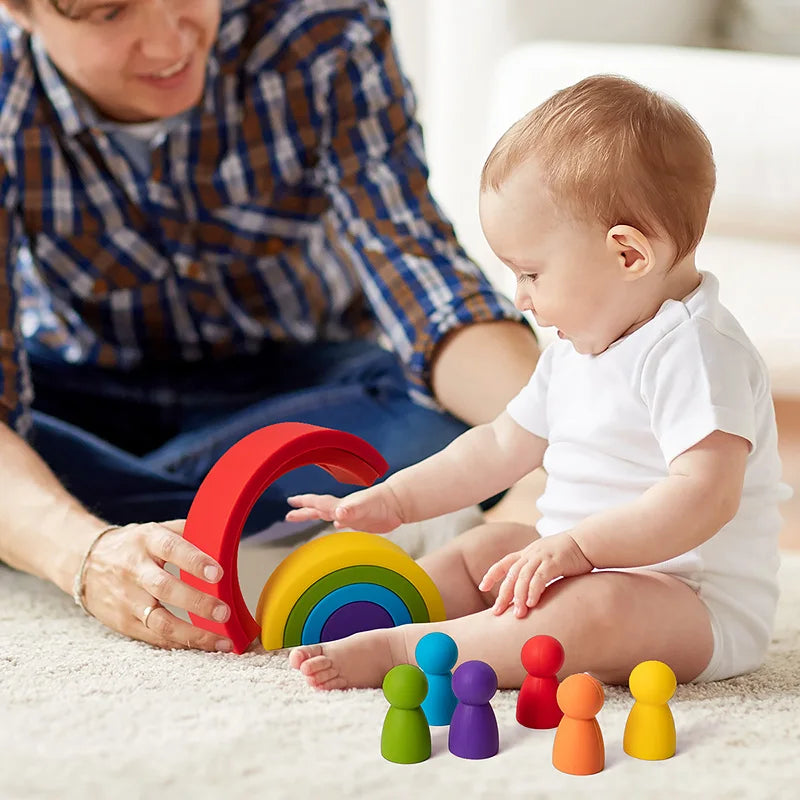 Baby playing with colorful silicone toys on a carpeted floor