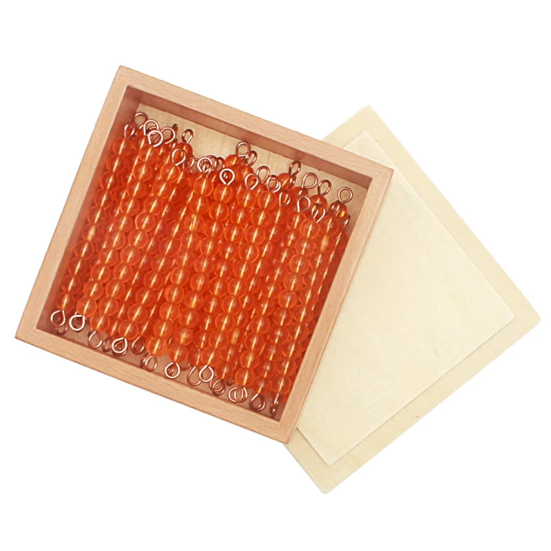 Golden ten bars in a wooden box with sliding lid