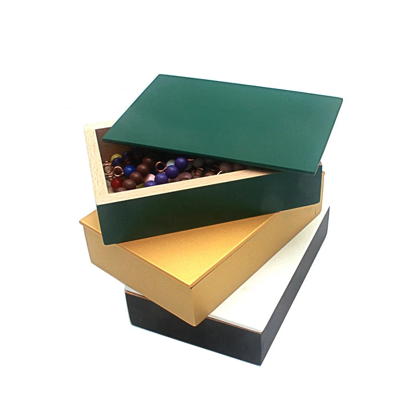 Three stacked snake game boxes with green, yellow and white lids