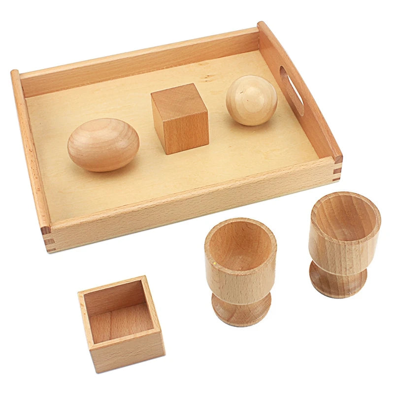 Wooden egg, ball and cube out of their holders