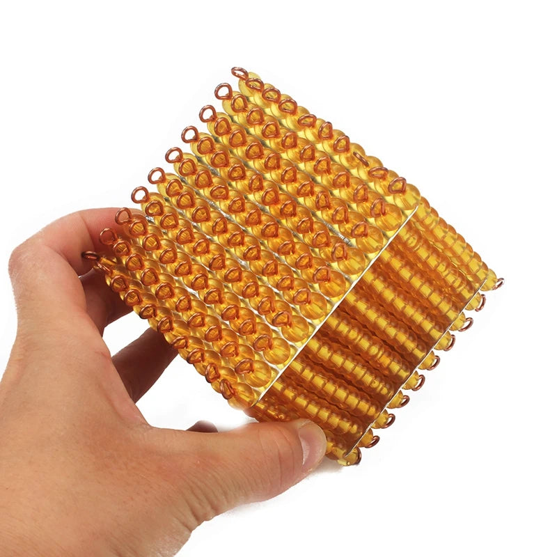 Hand holding the golden bead thousand cube