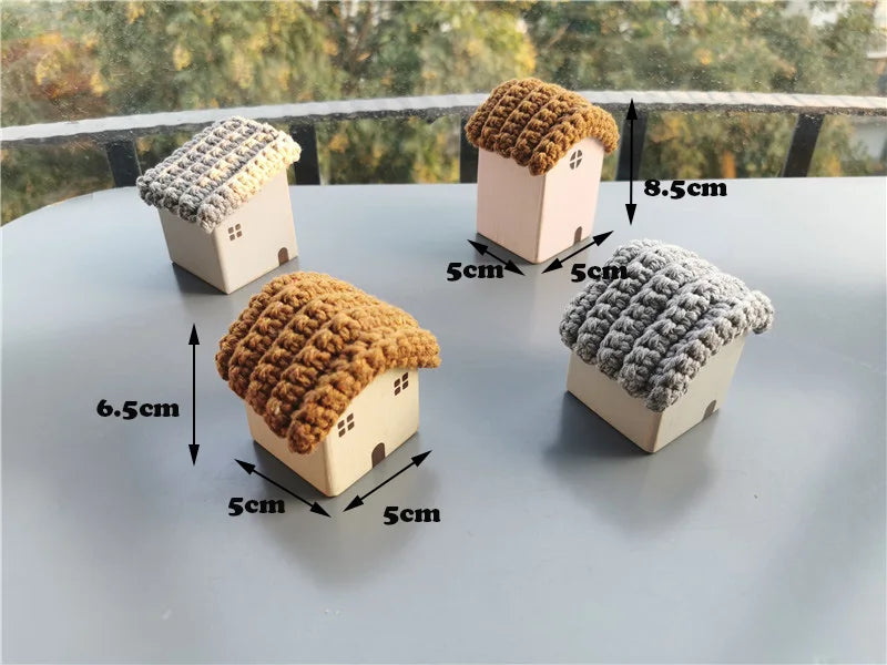 Four small house-shaped objects with textured roofs on a flat surface, with measurements indicated.