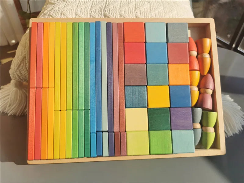 Colorful wooden blocks in a wooden box on a surface