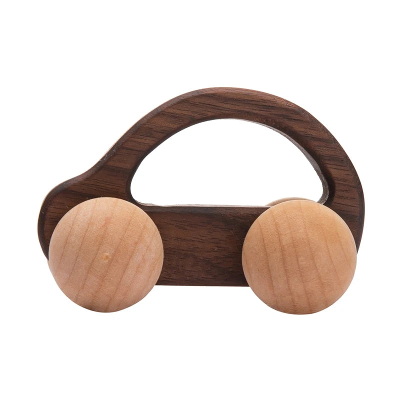 Wooden car-shaped toy with two round wooden balls on a white background