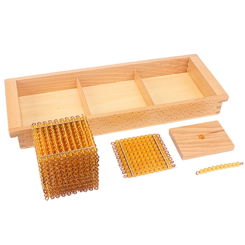 Golden bead cube, square, bar and unit beside a wooden tray