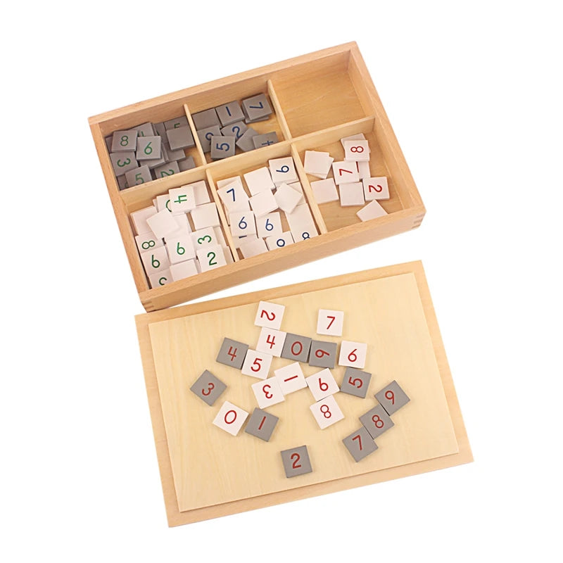 Gray and white number tiles in and beside the wooden box