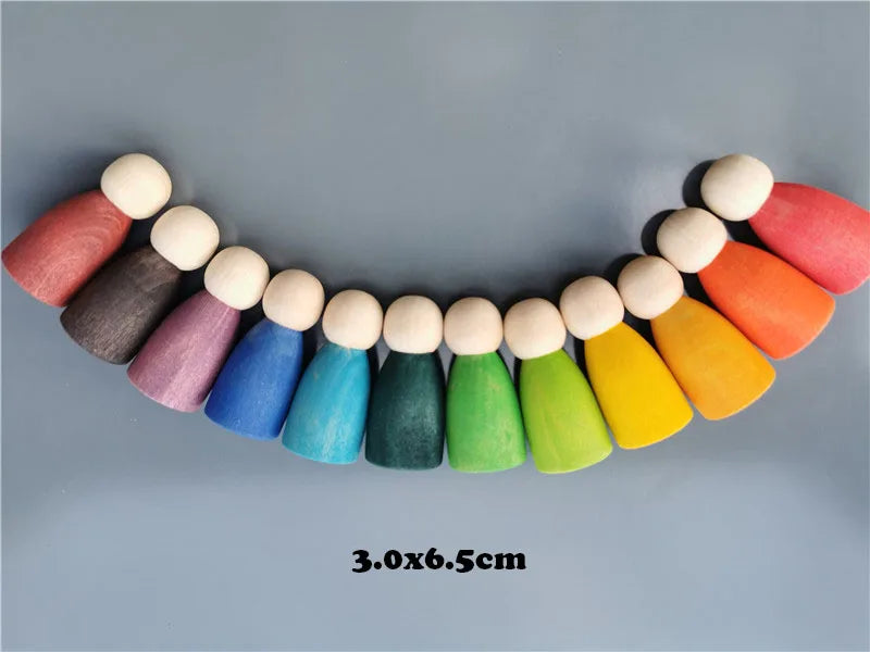 Colorful wooden peg dolls arranged in a row on a gray background