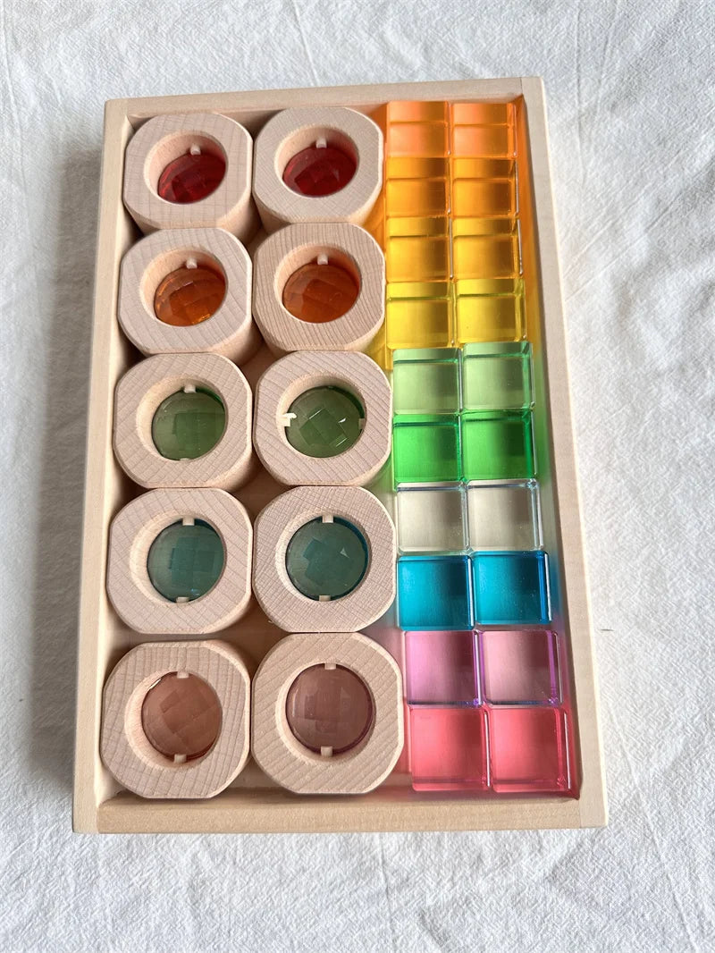 Color sorting toy with wooden blocks and transparent colorful blocks on a light background