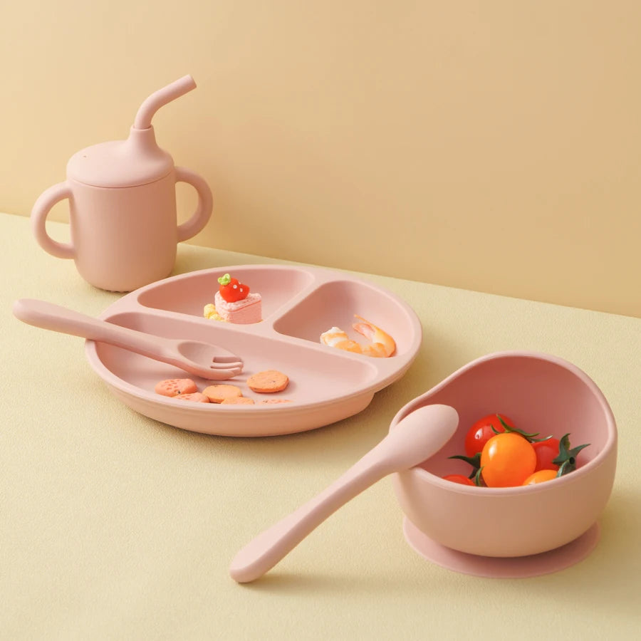 Light pink straw cup, divided plate and bowl with spoon and fork