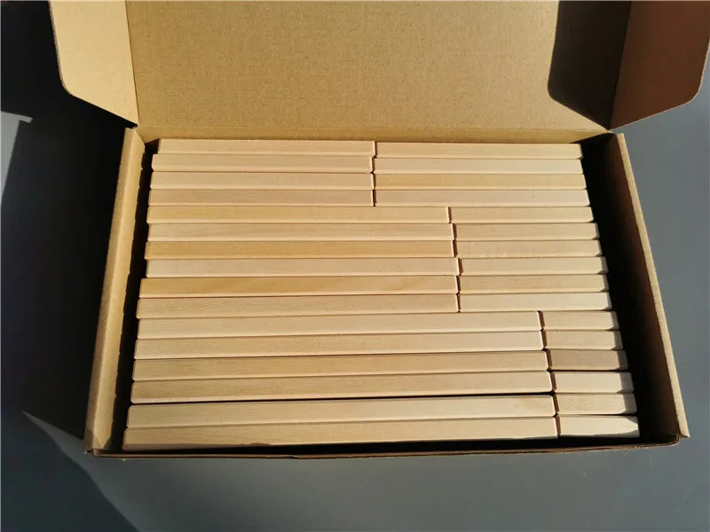 Box of wooden sticks on a gray background