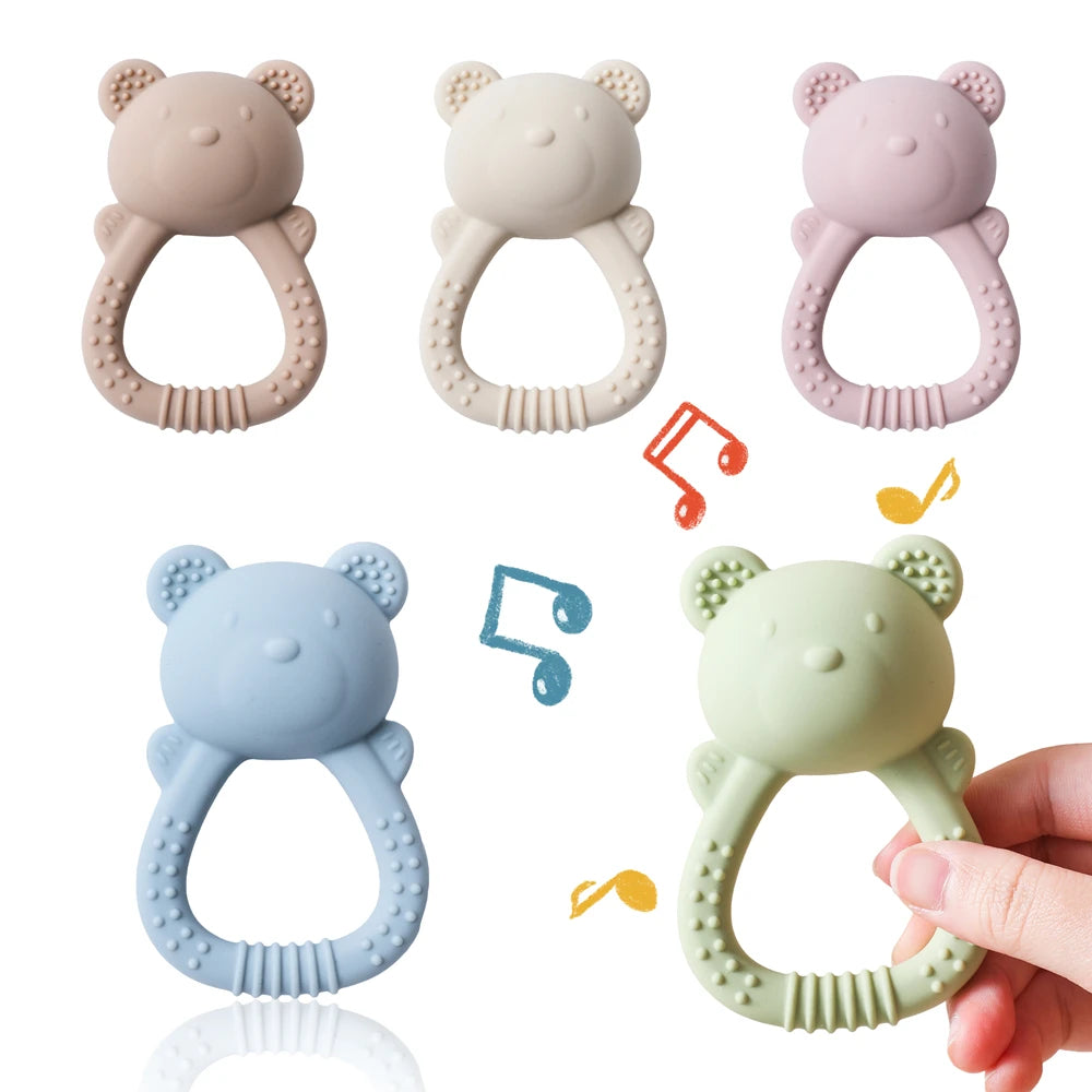 Set of five bear-shaped baby teething rings in different colors with a hand holding one green teething ring.
