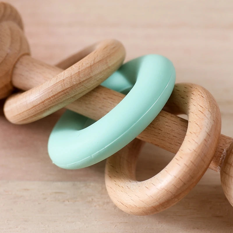 Wooden Baby Rattles with Silicone Rings, showcasing a close-up of the wooden texture and silicone rings, ideal for infants' sensory and motor skill development.