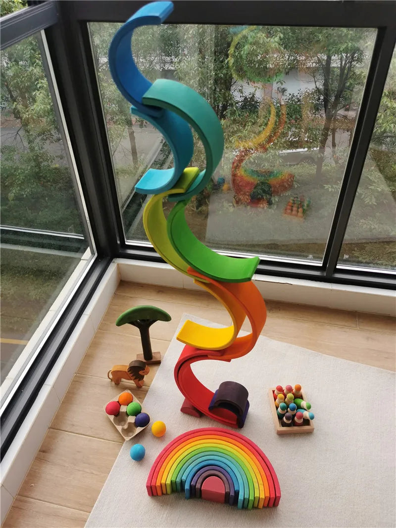 Colorful toy spiral and rainbow on a rug by a window with outdoor view