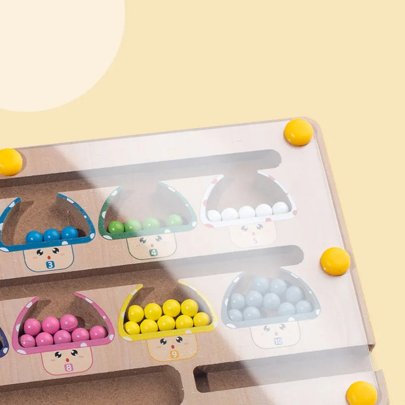 Educational toy with colorful beads and clear domes on a light yellow background