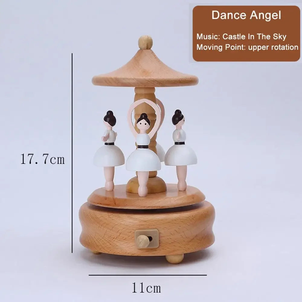 Wooden music box with three dolls and a lampshade, labeled 'Dance Angel', on a light gray background. | Oliver & Company Montessori Toys